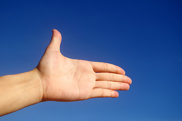 Image showing Give hand under blue sky