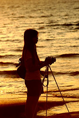 Image showing Female photographer under sunset