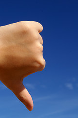 Image showing Thumbs down under blue sky