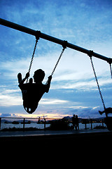 Image showing Man playing swing under sunset