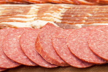 Image showing Assorted Slice Sausage and Bacon on Cutting Board