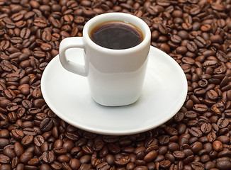 Image showing Cup with Hot Coffee on Coffee Beans