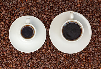 Image showing Cups with Hot Coffee on Coffee Beans