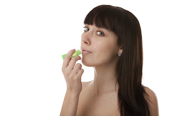 Image showing Girl paints her lips