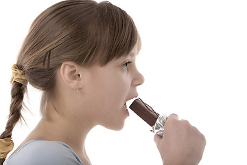 Image showing Girl eating chocolate bar