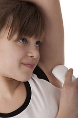 Image showing Girl applying deodorant on armpit