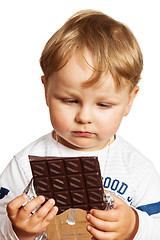 Image showing The little boy eats chocolate