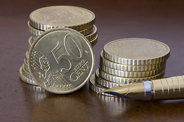 Image showing Stack of 50 cents euro coins  and pen