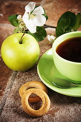 Image showing Cup of tea with an apple