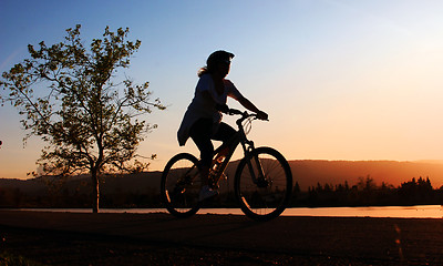 Image showing Woman riding her bike