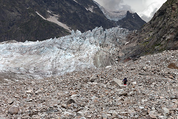 Image showing Hiker on glacier moraine