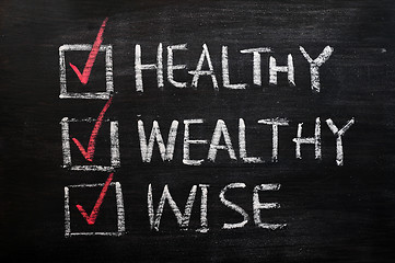 Image showing Being healthy, wealthy and wise written with chalk on a blackboard