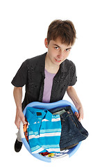 Image showing Boy holding a basket of clothes