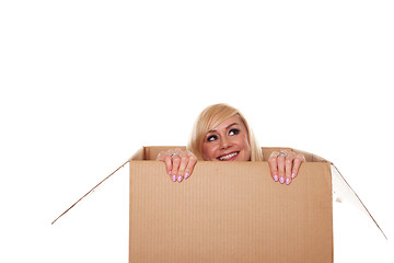 Image showing Smiling young blonde emerging from a box