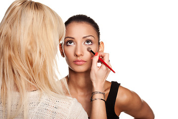 Image showing Makeup artist applying makeup to her model