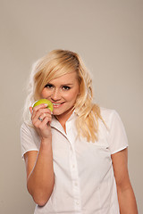 Image showing Smiling blonde with green apple