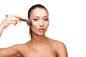 Image showing Young beautiful woman applying makeup