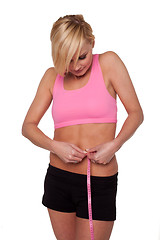 Image showing Sporty woman measuring her waist