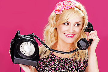 Image showing Woman talking on old telephone