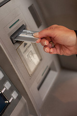 Image showing Female hand inserting ATM card