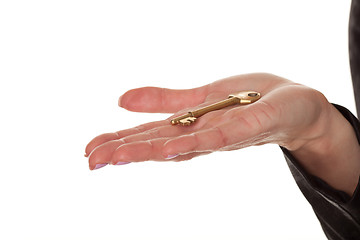 Image showing Female hand displaying a brass key