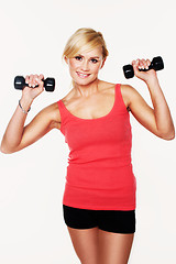 Image showing Fit woman lifting dumbbells