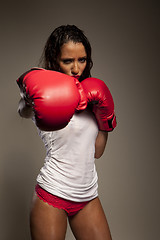 Image showing Athletic woman boxer throwing a punch