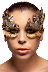 Image showing Woman wearing creative feather make-up