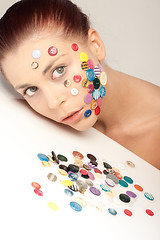 Image showing Beautiful woman with buttons on her face