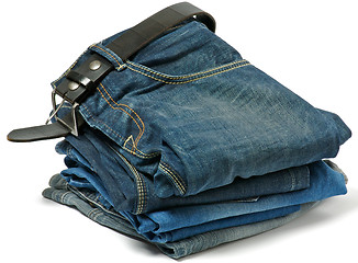 Image showing Stack of Old jeans and Belt