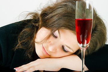 Image showing Sleeping girl and a glass of wine