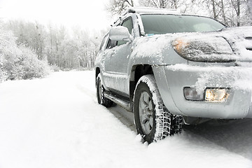 Image showing Snowy winter road behind an unrecognizable car