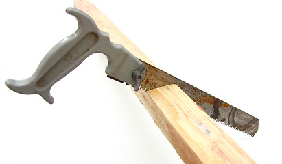 Image showing Hacksaw in sawed yellow wooden 