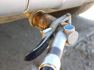 Image showing  refueling of the hybrid car by gas 