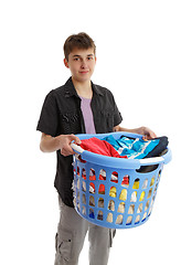 Image showing Teenager holding a basket of housework