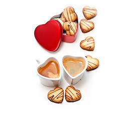 Image showing heart shaped cream cookies on red heart metal box and coffee