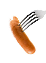 Image showing close up of sausage and fork on white background