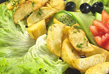 Image showing Fried fish with new potatoes, tomatoes, lettuce