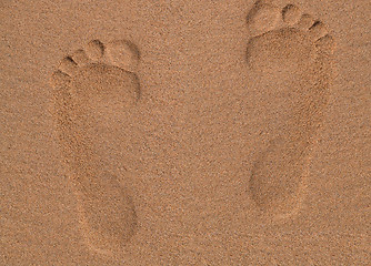 Image showing Two Footprints in sand at the Beach