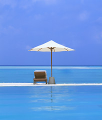 Image showing beach Chairs and Umbrella on a beautiful island