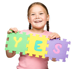 Image showing Cute little girl is holding Yes slogan