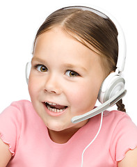 Image showing Cute little girl is talking to customers