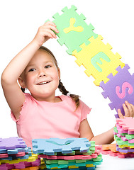 Image showing Cute little girl is holding Yes slogan