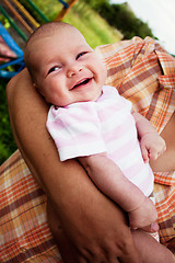 Image showing baby girl in her fathers hands