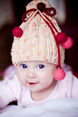 Image showing cute baby girl in yellow hat with colourfu bobbles