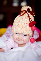 Image showing cute baby girl in yellow hat with bobbles