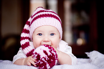 Image showing cute 6 month baby holding a bobble in her hands