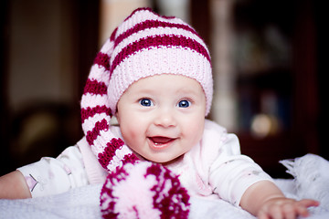 Image showing cute happy baby in a striped hat with bobble