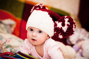 Image showing cute little baby in wool hat with pompoms