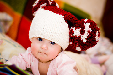 Image showing cute little baby in wool hat with pompoms